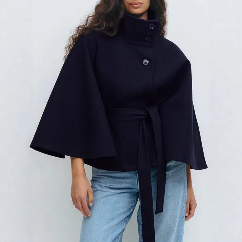 Navy cape jacket worn with light blue jeans, three buttons and a long belt tail 7