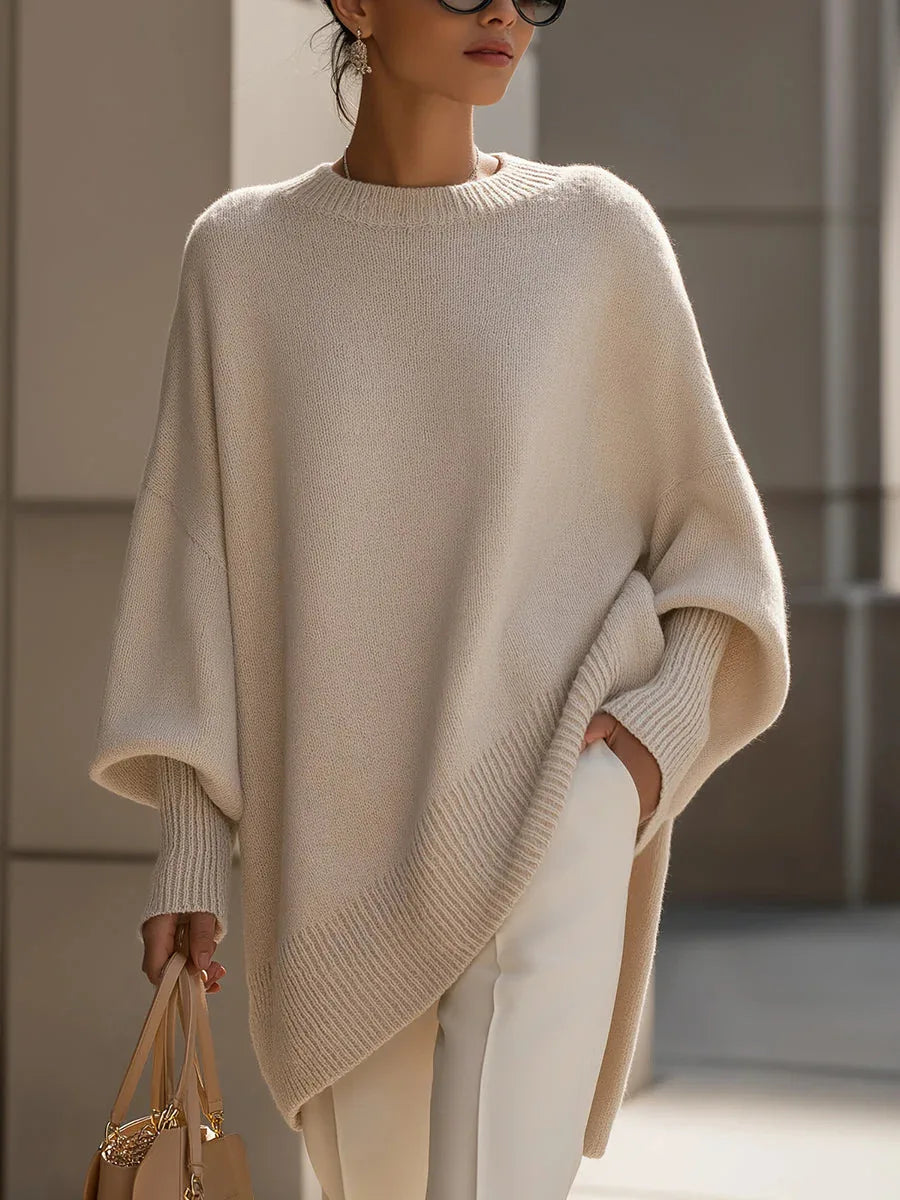 Close three-quarter view of the cream jumper, showing ribbed neckline, cuff and sloping hem 7