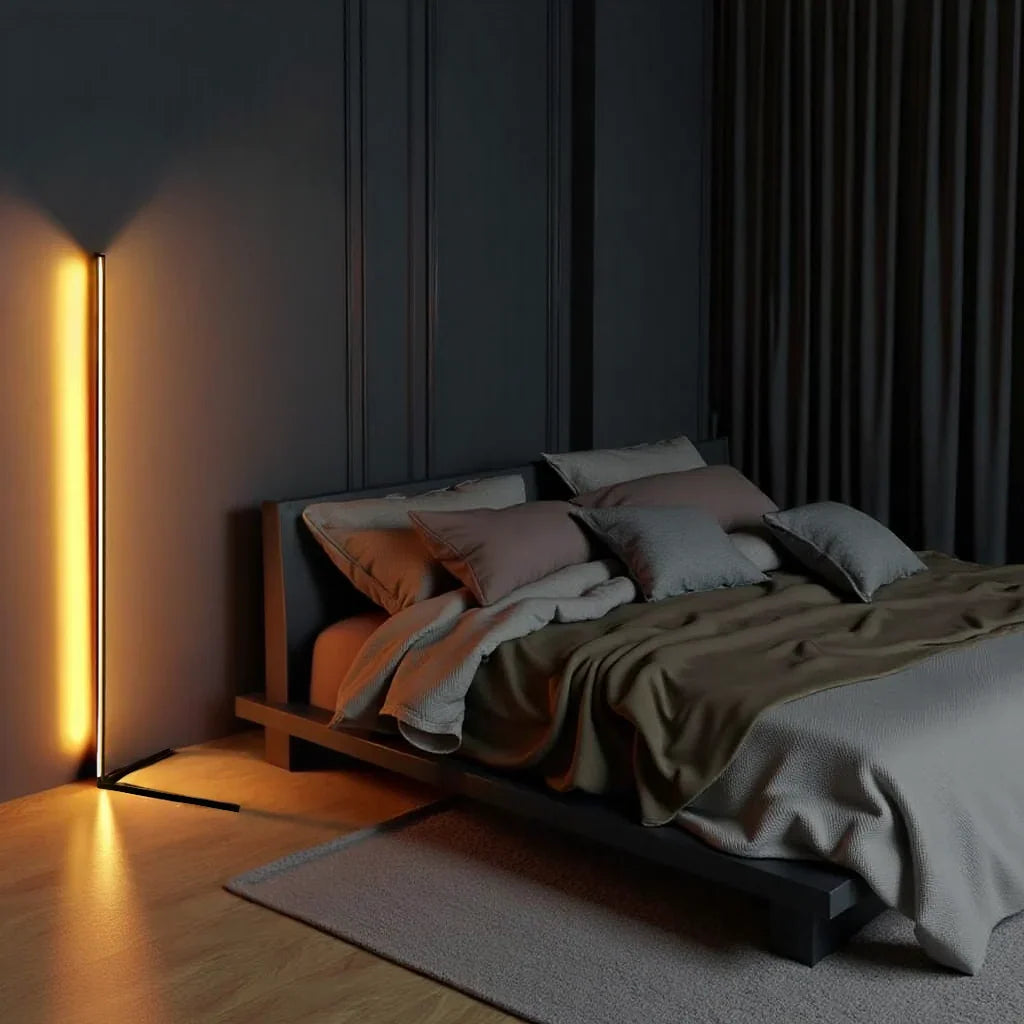 Lamp glowing amber against a dark panelled wall, next to a low platform bed 2