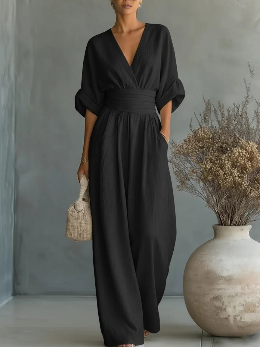 The jumpsuit in black, a larger view of the model with the wrapped V-neck, wide waistband and flowing wide legs. 5