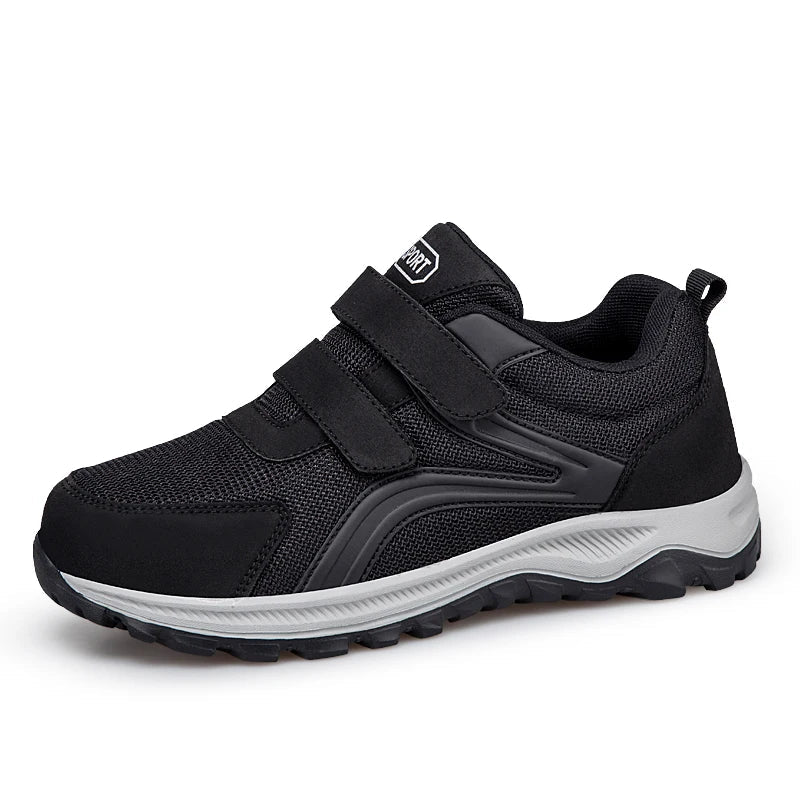 Black shoe with double straps and a grey sole, angled side-front view on white 15