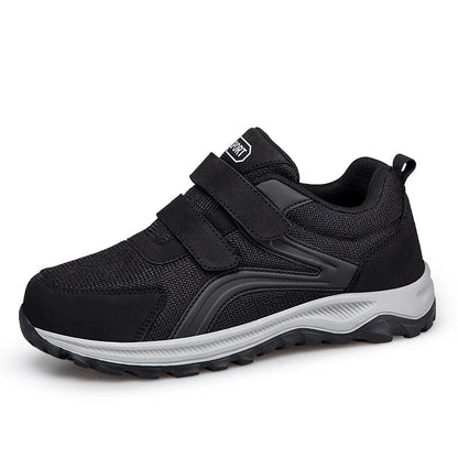 Black shoe with double straps and a grey sole, angled side-front view on white 15