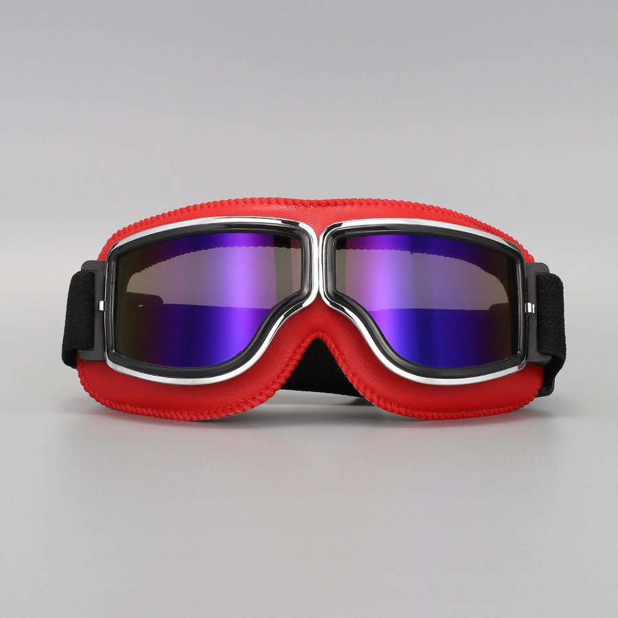 Front view of the red-padded goggles with chrome trim and purple-blue mirrored lenses. 12