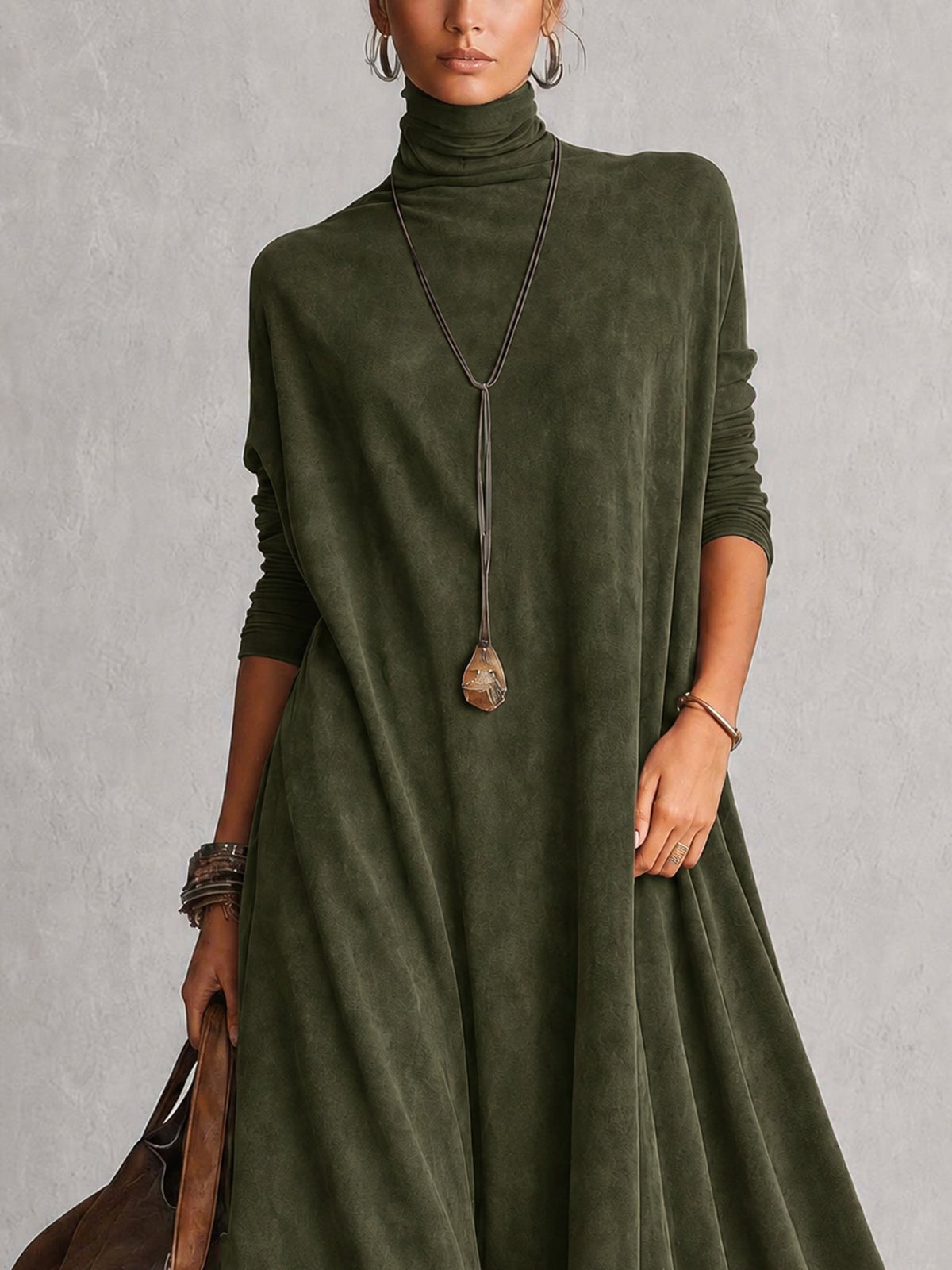 Close-up of the olive green dress's turtleneck and long sleeves, worn with a pendant necklace 15