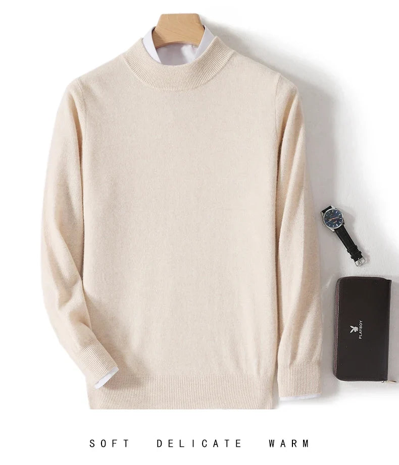 Cream mock neck jumper on a hanger with white shirt underneath, watch and dark wallet beside it 8