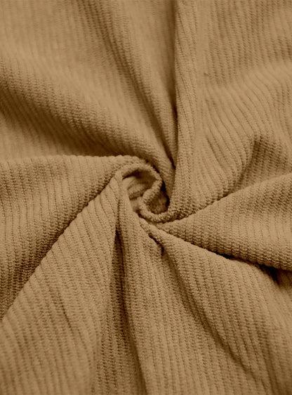 Close-up of tan ribbed fabric twisted into a swirl to show its texture 8