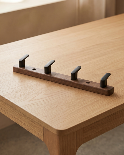 Four-hook version lying on an oak table, with two screw holes visible along the board 7