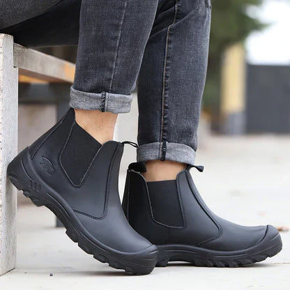 Model in rolled grey jeans sitting on a concrete bench wearing black leather pull-on boots outdoors 8
