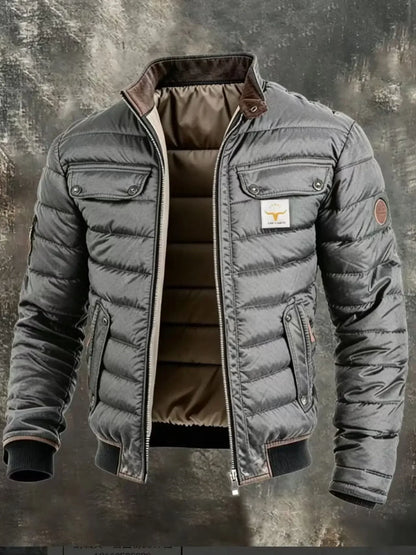 Close, large view of the grey quilted jacket, showing glossy horizontal quilting, flap pockets and ribbed hem 8