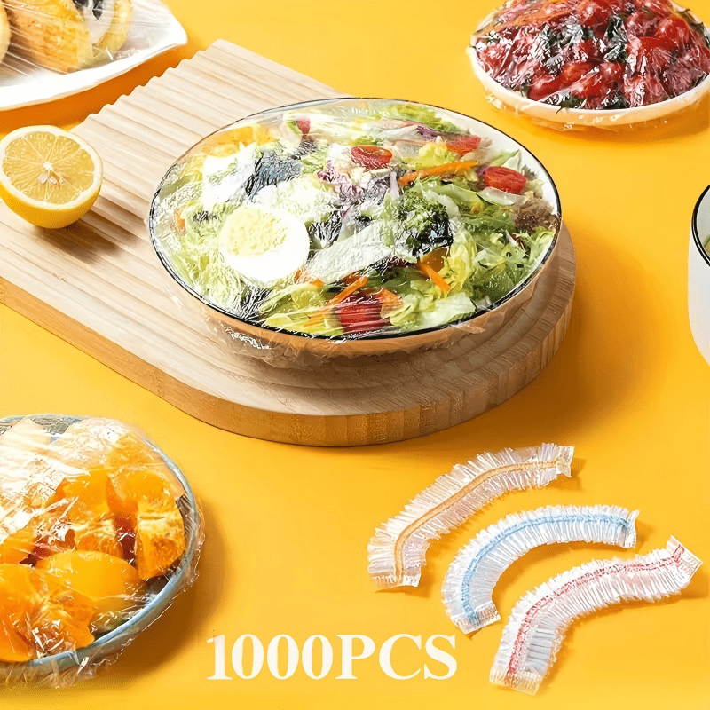 Covered bowl of mixed salad on a wooden board, with three coloured-band covers laid out in front on a yellow surface. 9