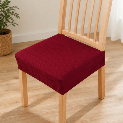 Deep red textured seat cover fitted on a light wooden slatted chair, with a woven basket and plant nearby. 14