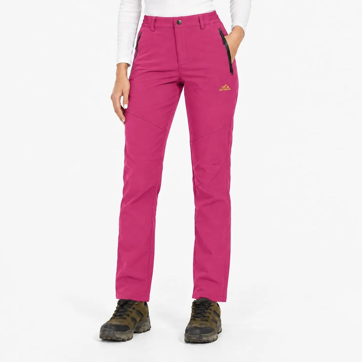 Bright pink trousers worn with hiking boots, front view showing zipped pockets and small chest logo 6
