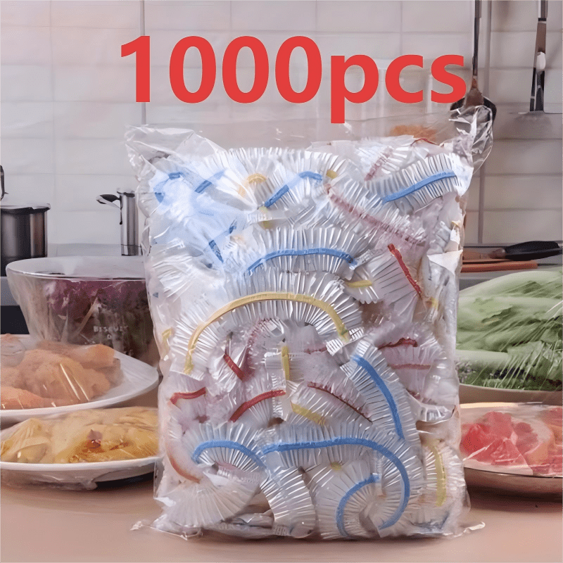 Clear bag of banded elastic covers on a kitchen counter, with covered plates of food on either side of it. 3