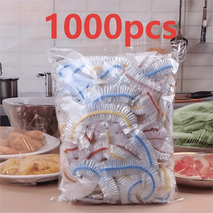 Clear bag of banded elastic covers on a kitchen counter, with covered plates of food on either side of it. 3