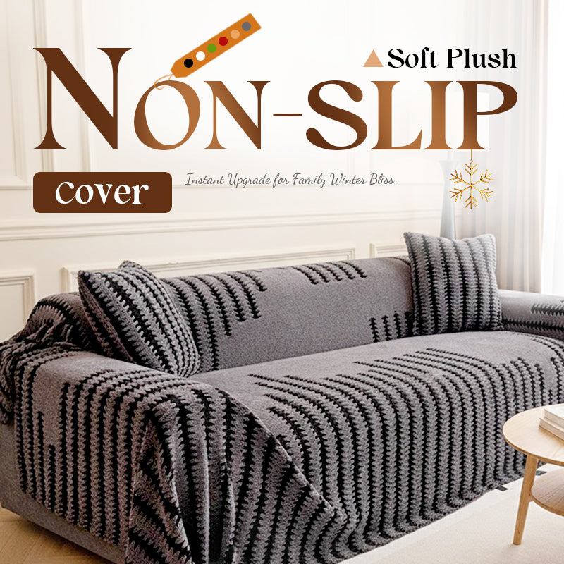Grey plush sofa cover with black zigzag stripes draped over a sofa with matching cushions 1