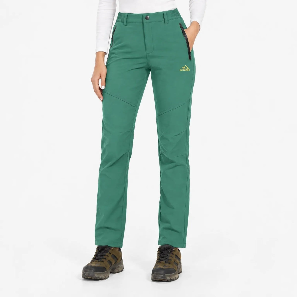 Green trousers worn with hiking boots, front view showing button waist and zipped pockets 13
