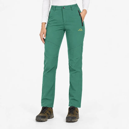 Green trousers worn with hiking boots, front view showing button waist and zipped pockets 13