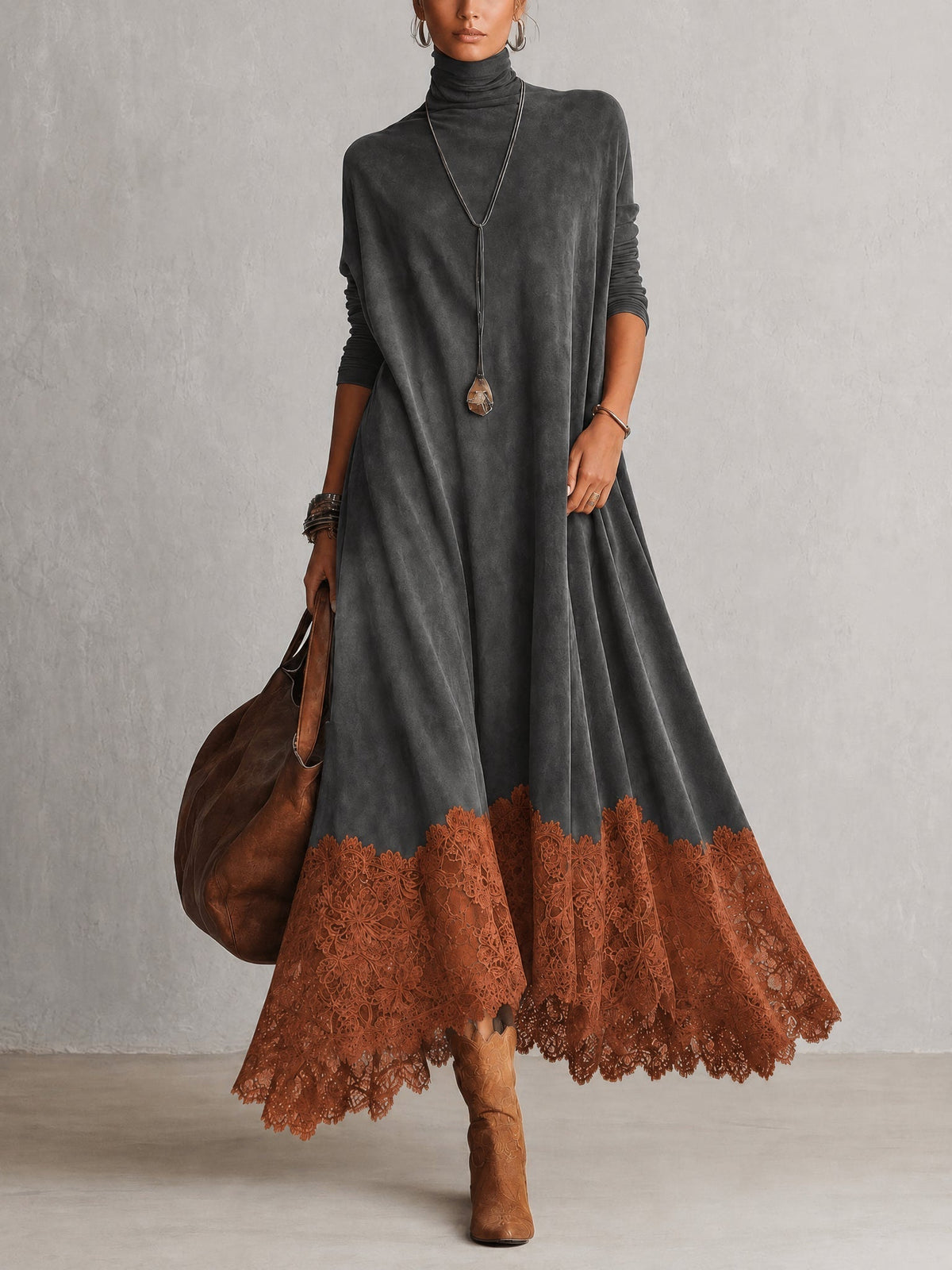 Model in dark grey roll-neck maxi dress with rust-orange lace hem, full-length front view 5
