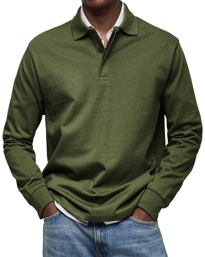 Model wearing the polo in dark olive green, ribbed cuffs and buttoned collar, layered over a striped shirt. 10