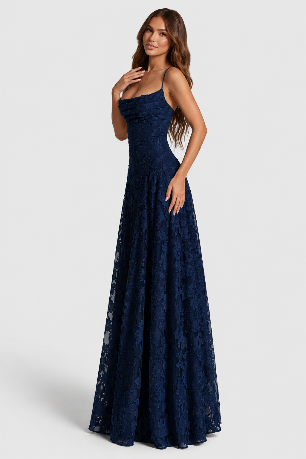 Model angled to the side in a navy lace gown, hand at her chest, showing the fitted bodice and A-line skirt. 13