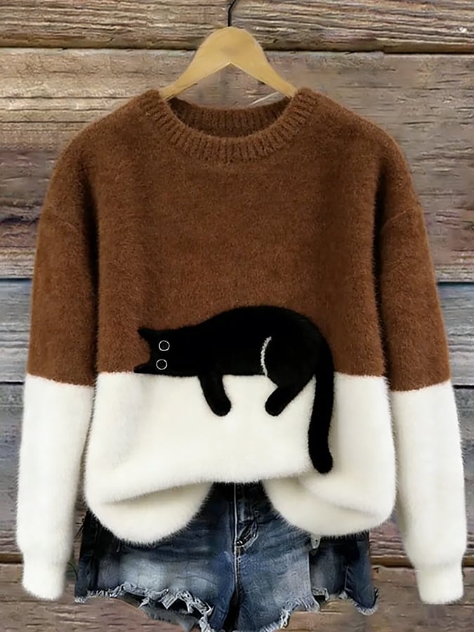 Fluffy jumper with brown upper half, white lower half and black cat patch, on a hanger 9