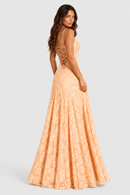 Back view of a peach floral lace gown with criss-cross lace-up back, model glancing over her shoulder. 14