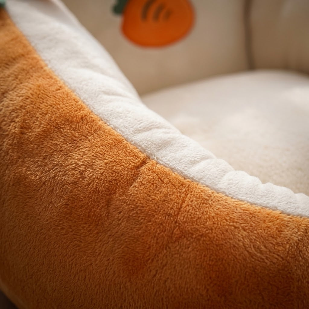 Close-up of the soft orange velour outer and cream plush trim, with the embroidered carrot behind 2