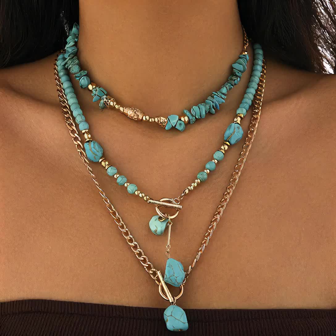 Close view of the layered necklaces on a model, highlighting the stone pendants and chunky gold-tone chain 8