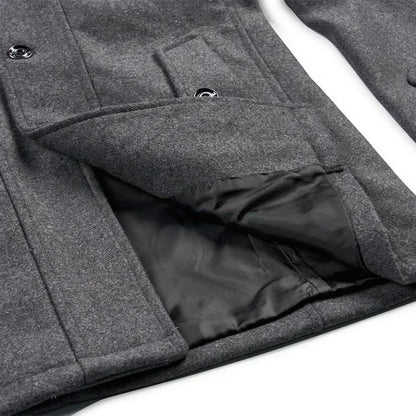 Close-up of the grey coat's lower front, with a pocket flap lifted to reveal the black lining 9