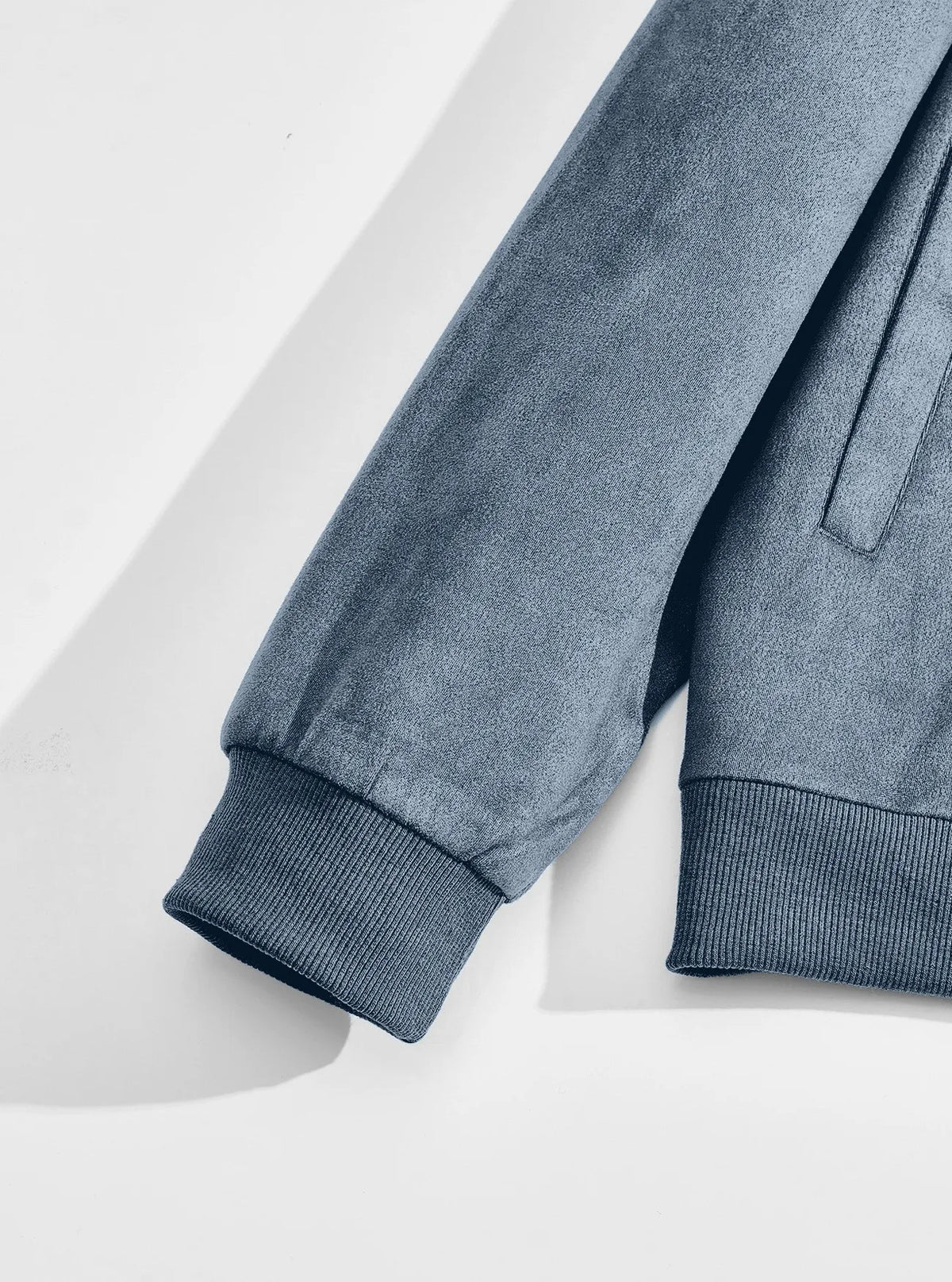 Flat view of a light blue sleeve with ribbed cuff, hem and slanted pocket 9