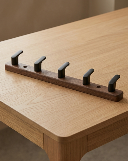 Five-hook version lying on an oak table, with two screw holes visible along the board 8