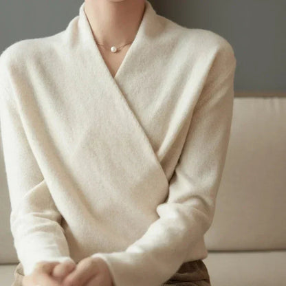 Close crop of the cream crossover neckline and soft knit, worn with a pearl pendant necklace 3