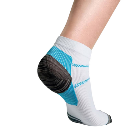 Rear three-quarter view of a white ankle sock worn on a bare leg, showing the blue heel panel and dark grey heel cup. 1
