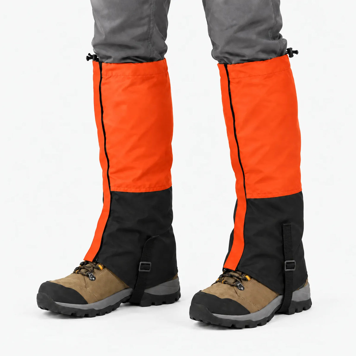 Orange and black gaiters worn over hiking boots against a white background, showing the zip, top drawcord and instep strap. 12