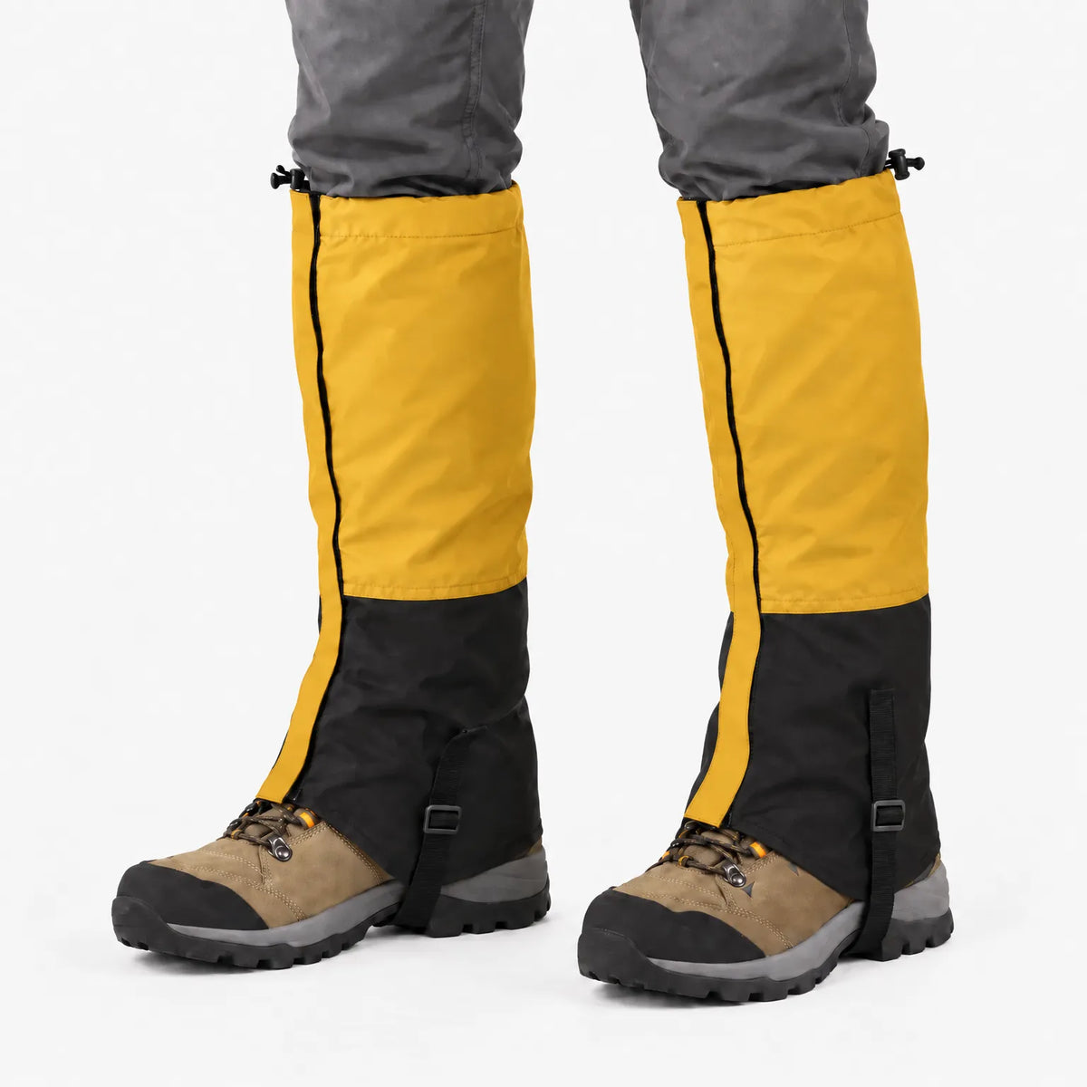 Mustard yellow and black gaiters worn over tan hiking boots, with a black side zip, top toggles and instep strap. 13