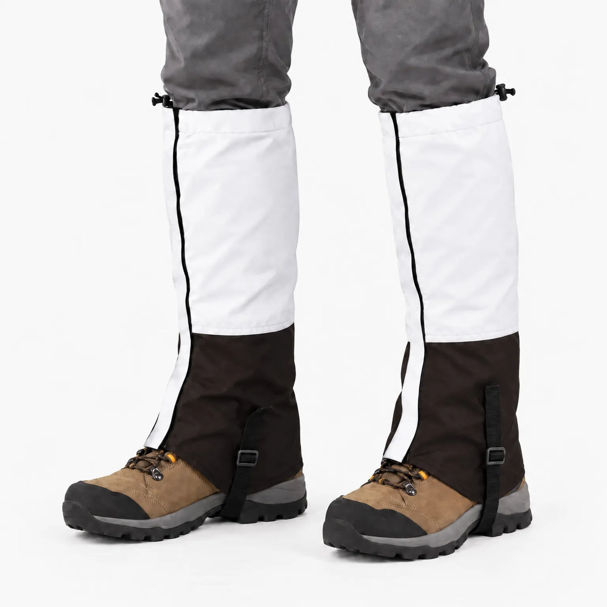 White and dark brown gaiters worn over hiking boots, with a top drawcord, side zip and adjustable instep strap. 7
