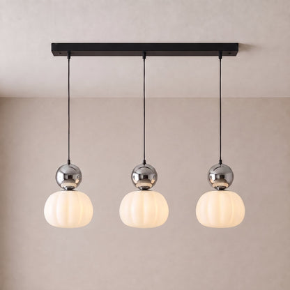 Three-head pendant with chrome caps and fluted shades on a black rectangular ceiling plate 9