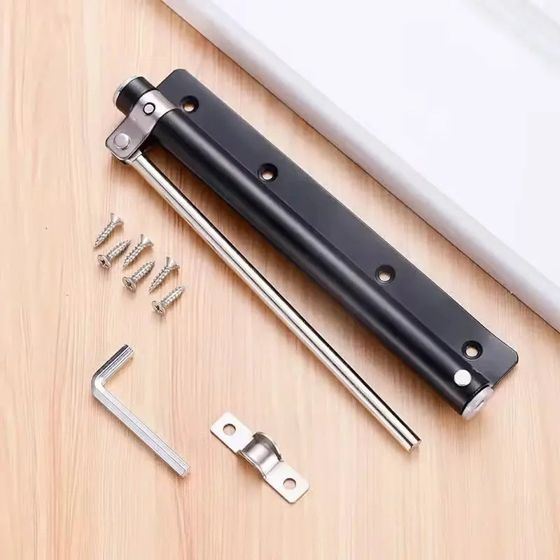 Black closer laid flat on a wooden surface with its screws, Allen key and door bracket 7