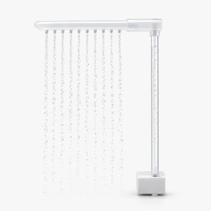 Side view of the spray arm on a clear vertical tube above the square pump base, with water streaming from ten nozzles. 4
