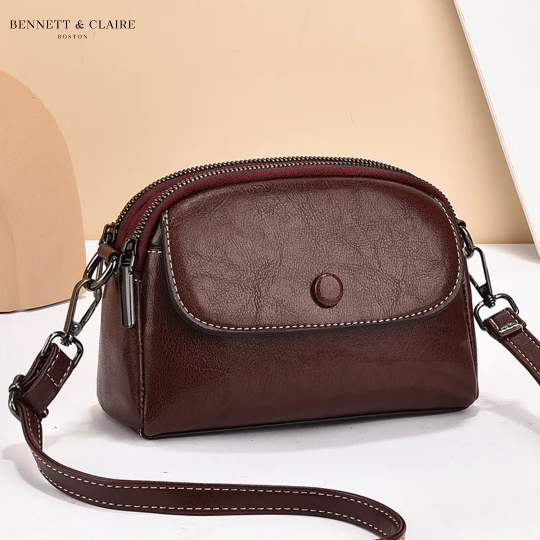 Deep burgundy-brown version of the crossbody bag with a stitched front flap, round press stud and dark metal strap hardware. 3