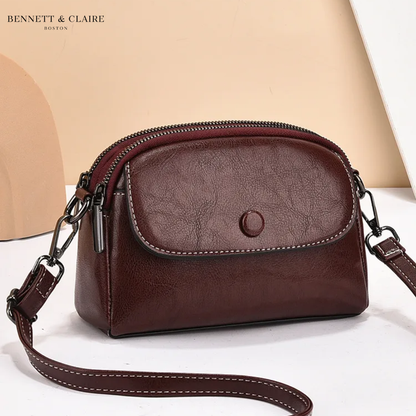 Deep burgundy-brown version of the crossbody bag with a stitched front flap, round press stud and dark metal strap hardware. 3