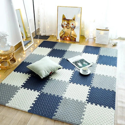 Interlocking foam tiles in navy, grey and cream laid as a chequered rug in a cosy room with a cushion and fairy lights. 1