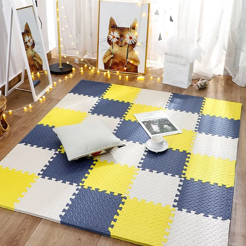 Yellow, navy and cream foam tile mat in a room with a cushion, a cup on a saucer and a magazine. 11