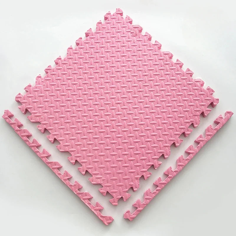 Single pink foam puzzle tile with a leaf-pattern surface, shown flat with two separate border edge pieces. 12
