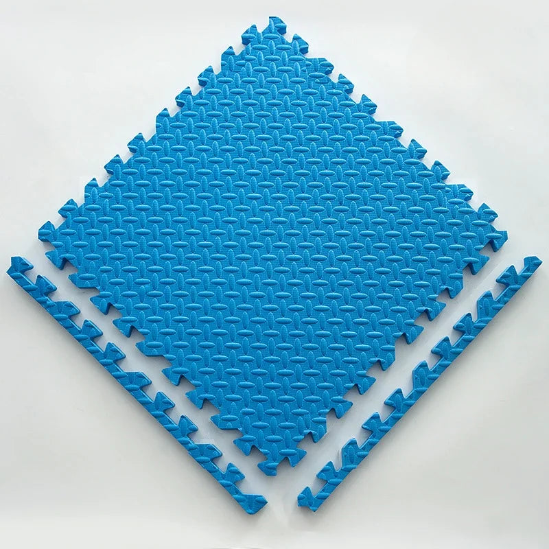 Single bright blue foam puzzle tile with an embossed leaf pattern, shown flat with two separate edge pieces. 14