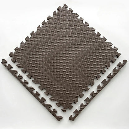Single brown foam puzzle tile with an embossed leaf pattern, shown flat with two separate border edge pieces. 15