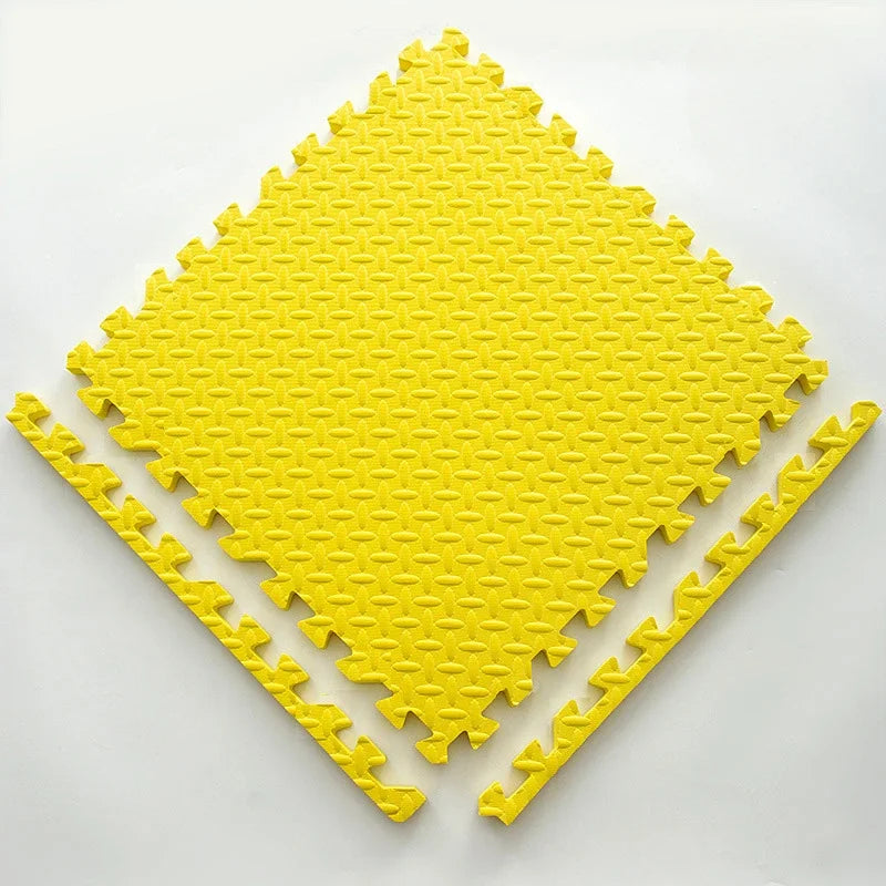 Single yellow foam puzzle tile with a textured leaf pattern, shown flat with two separate border edge pieces. 16
