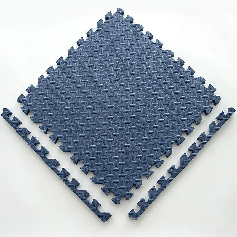 Single navy blue foam puzzle tile with an embossed leaf pattern, shown flat with two separate border edge pieces. 17