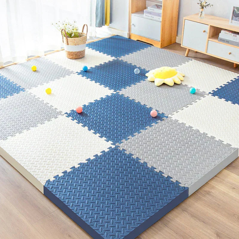Thick navy, grey and cream foam tiles in a living room with small play balls and a sunflower cushion, showing the tile edge. 9