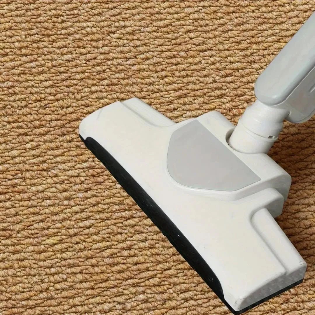 Close-up of the tan looped pile with a vacuum cleaner head running across it 8